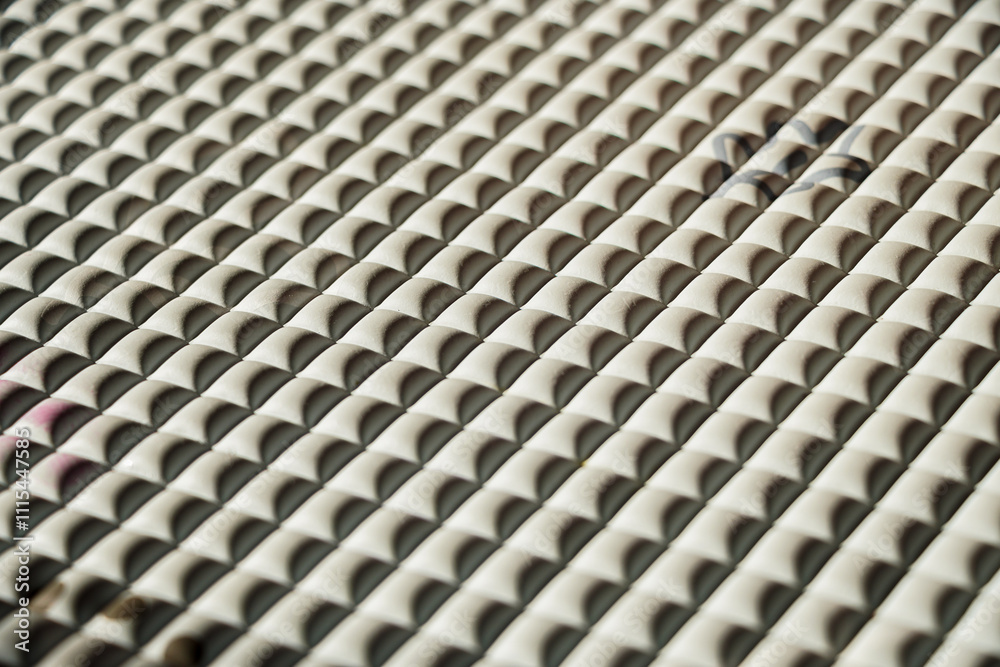 Poster close-up of a textured surface with repeating geometric shapes. the pattern is visually interesting 