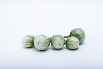 Healthy green round mini eggplant vegetable photographed with white base and background