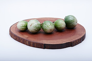 Healthy green round mini eggplant vegetable photographed with white base and background