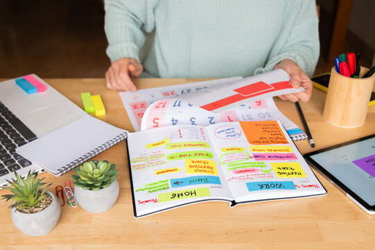 Efficient Woman Planning Calendar For Home Or Work, Setting Goals, Managing Events, Meetings, Budget, Productivity, Time Management, Finances, Daily Expenses, And New Beginnings Concept.  