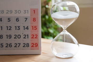 Concept Of Time Management With Hourglass And Calendar On Table, Ideal For Illustrating Deadlines,...
