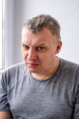 Obraz premium portrait of an aggressive angry man with a face distorted with hatred and malice