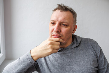 distorted face of a sad and sorrowful very upset man