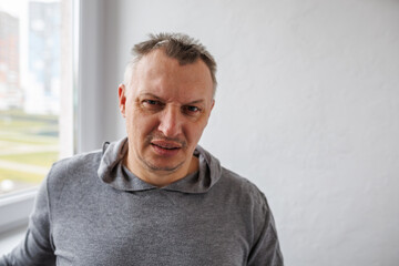 Obraz premium distorted face of a sad and sorrowful very upset man