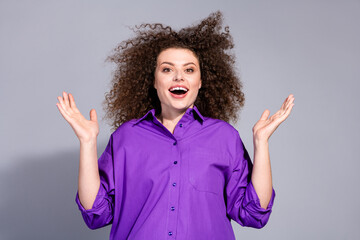Portrait of pretty young woman raise arms open mouth wear violet shirt isolated on grey color...