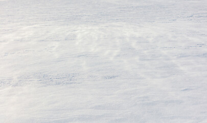 White snow on the ground as abstract background. Texture.