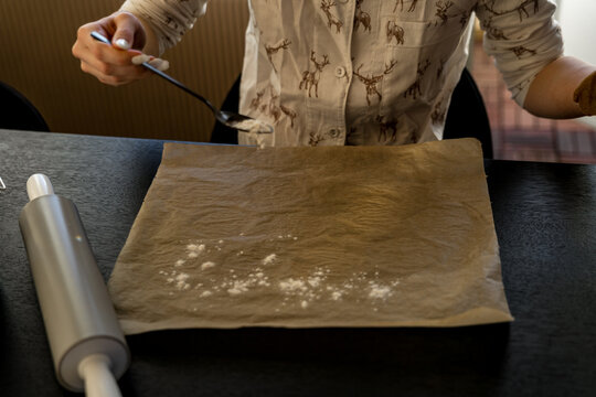 Flour sprinkled on parchment paper for baking