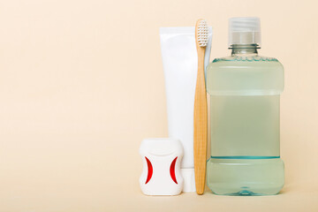 Mouthwash and other oral hygiene products on colored table top view with copy space. Flat lay....