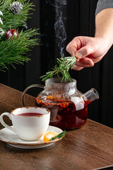 winter tea in a teapot and a mug next to it