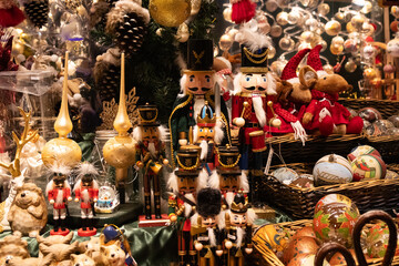 Decorated lead soldiers nutcracker and Christmas tree toys stand in the window at Christmas markets