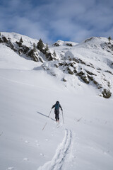 Ski touring in the french alps. Skier in the fresh snow.