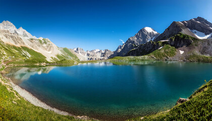 Naklejka premium Majestic Mountain Vista with Tranquil Lake