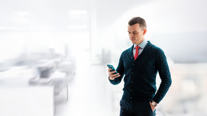 Successful smiling ambitious caucasian european businessman lawyer in suit standing in light office with laptop and phone