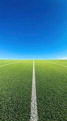 Obraz premium A clear sky over a green sports field with a white line marking.