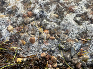 Wave rolling in on stony beach