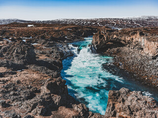 Cascades et rivière turquoise dans un paysage volcanique près de Goðafoss en Islande