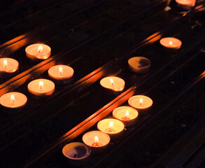 Rows of Flickering Candles Creating a Warm and Tranquil Atmosphere