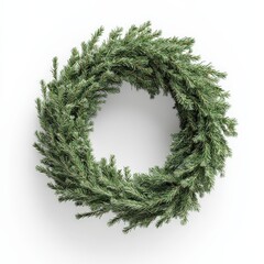 A wreath made of green branches is sitting on a white background