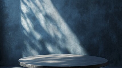 Empty table on dark blue texture wall background. Composition with organic shadow on the wall and light reflections. Mock up for presentation. 