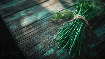 Here's a caption and keywords for the image.. Fresh chives bunch on rustic wood.