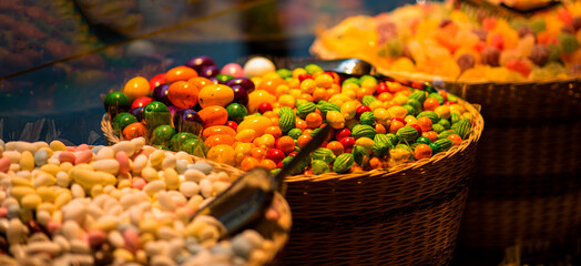 Variety of colorful candies displayed at sweet store. Large choice of sweets in a candy shop.
