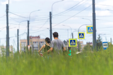 View from back of young couple walking down street in embrace