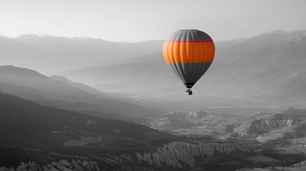 A hot air balloon flying over a mountain range.