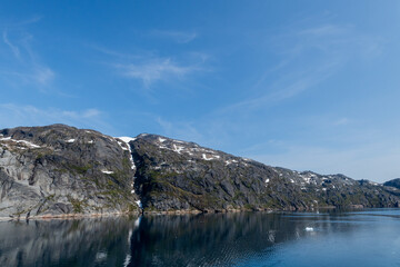 Fototapeta premium Prins Christian Sund Greenland mountain fjord with floating ice and shore iceberg on a summer day