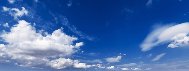 panorama with white clouds in a blue sky. Background with a copy space