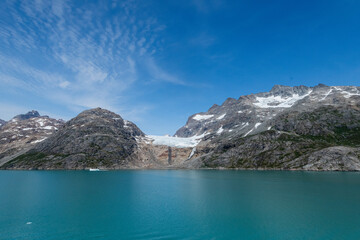 Prins Christian Sund Greenland mountain fjord with floating ice and shore iceberg on a summer day