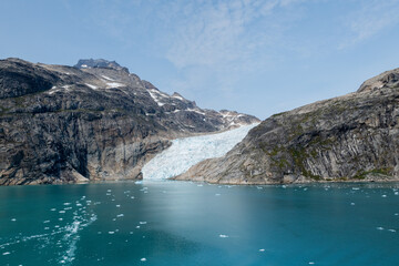 Prins Christian Sund Greenland mountain fjord with floating ice and shore iceberg on a summer day