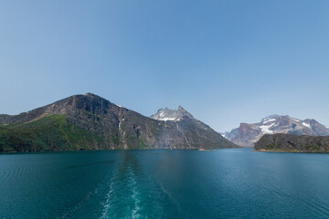 Prins Christian Sund Greenland mountain fjord with floating ice and shore iceberg on a summer day