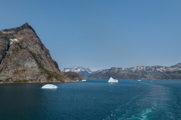 Prins Christian Sund Greenland mountain fjord with floating ice and shore iceberg on a summer day