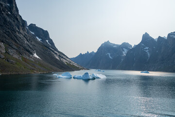 Prins Christian Sund Greenland mountain fjord with floating ice and shore iceberg on a summer day