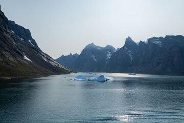 Prins Christian Sund Greenland mountain fjord with floating ice and shore iceberg on a summer day