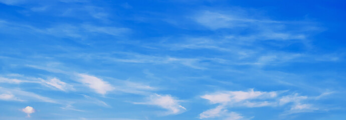 Fototapeta premium panorama with white clouds in a blue sky. Background with a copy space