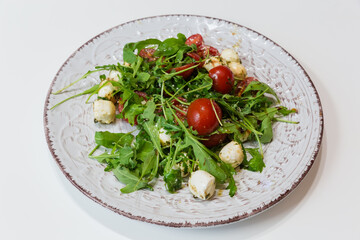 Vegetable salad with mozzarella, cherry tomato, arugula, pesto sauce