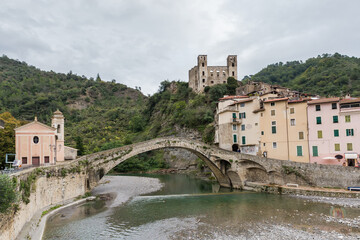 Fototapeta premium Medieval arched stone bridge against Old town in Dolceacqua, Italy