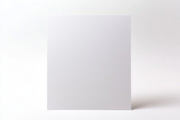 A blank sheet of white paper sits against a light background, offering a simple and minimalistic canvas for creativity and expression.