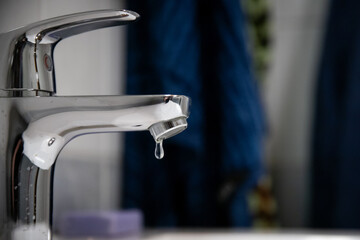 Close-up of a leaking faucet dripping water