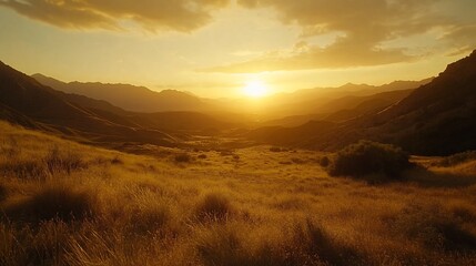 Golden sunset over a vast, mountainous landscape.