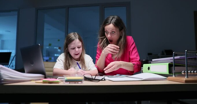 Daughter prevents mother from working with documents spoils important papers late at night in office. Children at work concept