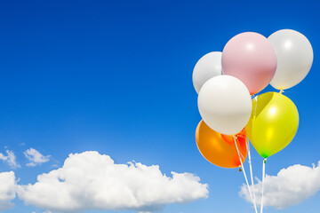 Balloons in the sky with clouds. Balloons sky clouds colored balls blue. Colored blue clouds and blue balls in the sky. Two red and white balloons in the sky lifestyle.