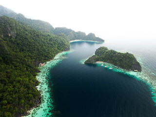 Breathtaking aerial shot showcasing lush tropical islands, coral reefs, and pristine turquoise waters in Coron, Philippines