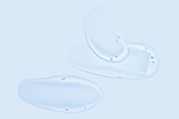 Glycerin gel texture. Transparent serum smears on blue background. Liquid gel moisturizer with bubbles macro