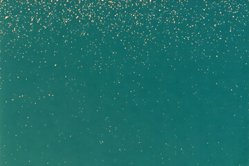 Fototapeta premium Teal background with gold glitter; perfect for festive designs, invitations, and digital projects. Elegant and shimmering texture.