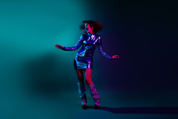 Full length photo of lovely young lady dance dressed stylish nightclub retro garment isolated on dark background