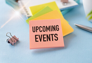 Upcoming Events sign on the torn paper on the Blue Background