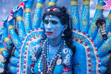 Kulasai Dasara, Portrait of indian male with painted face and dressed as hindu goddess kali to...
