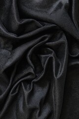 Fototapeta premium A close-up view of a sleek, crumpled black fabric showcasing its luxurious texture and elegant appearance.